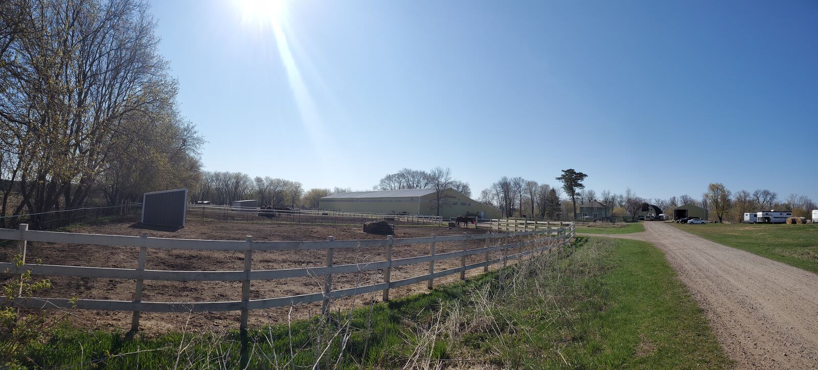 Fenced paddocks along the farm's dirt road